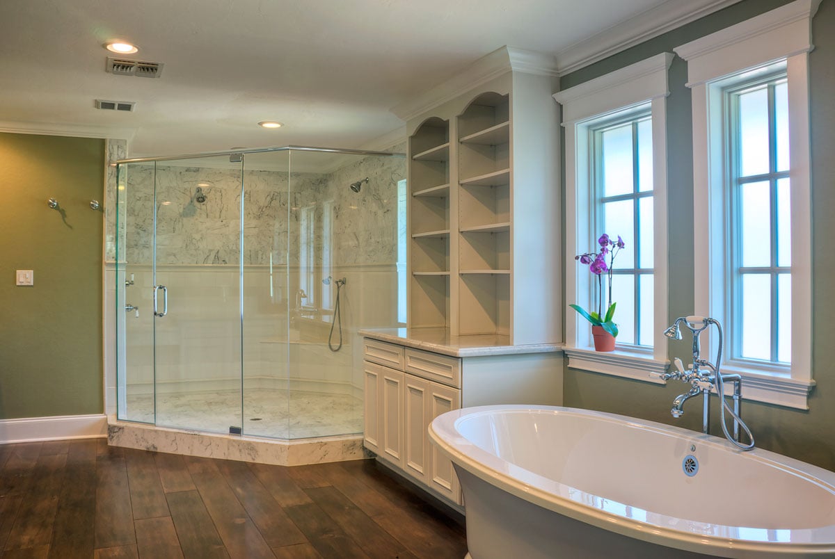Master bathroom full view with hard wood flooring, a walk in shower, and white shelving