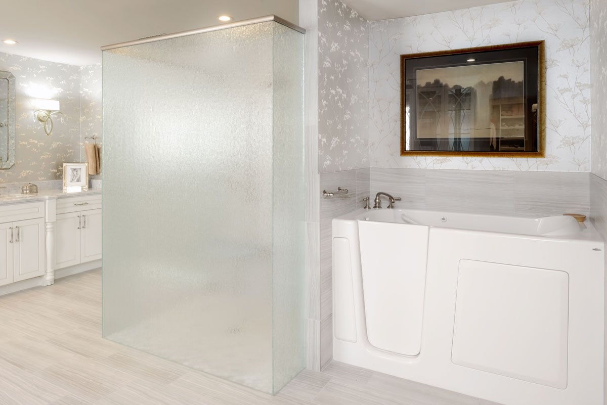 Master bathroom with walk in tub and fogged glass shower