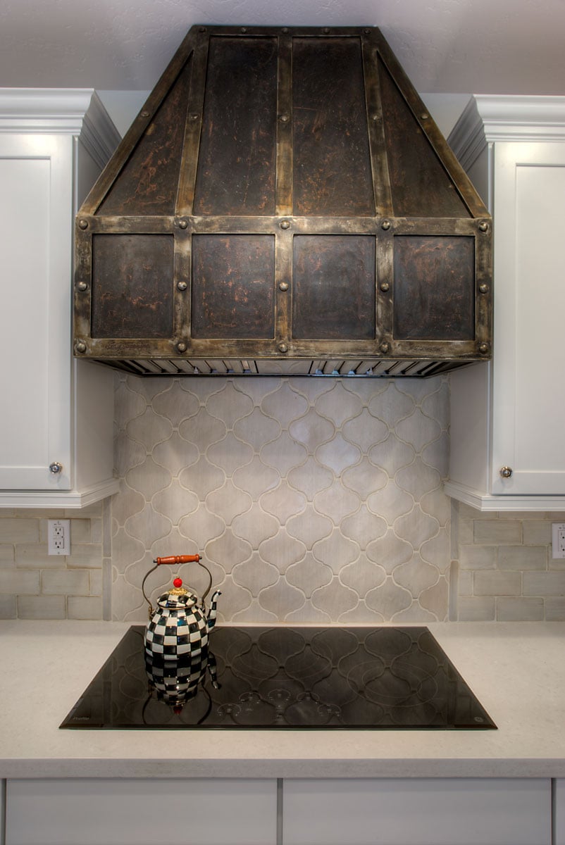 Electric stove on top of white marble countertop