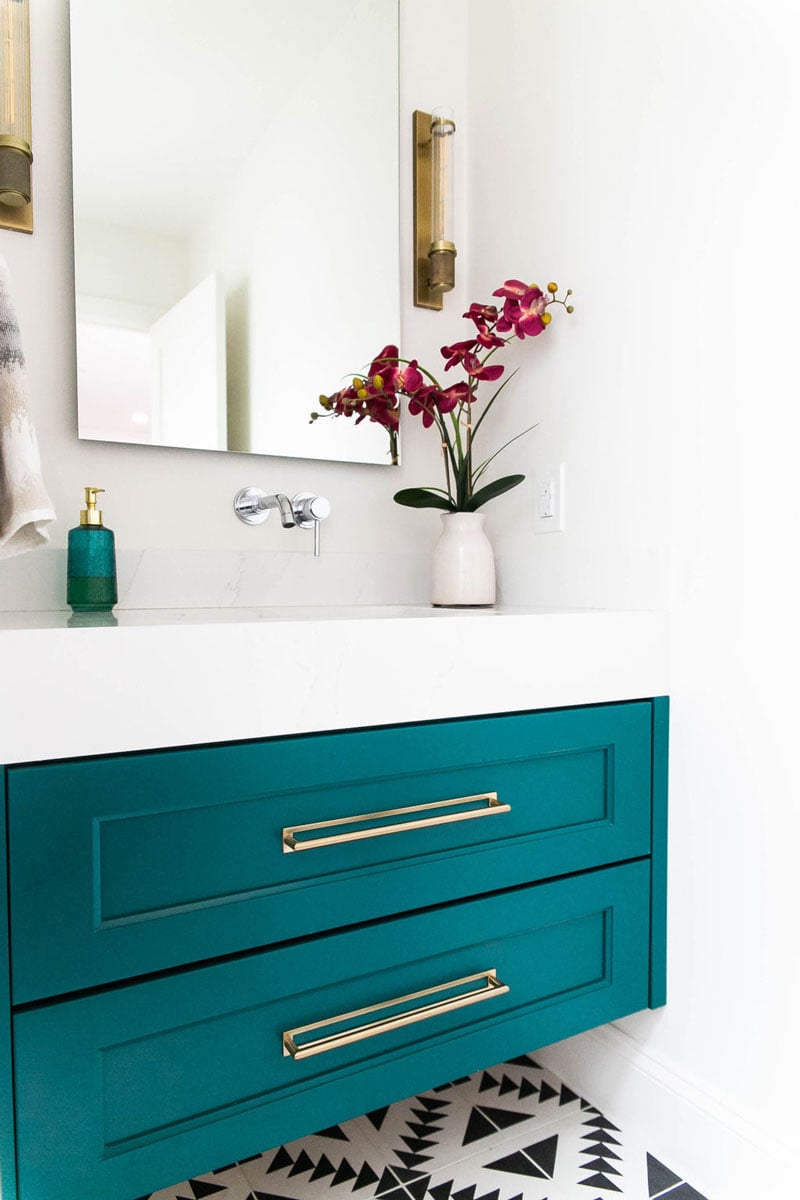 Angled view of single vanity bathroom with bright saturated color