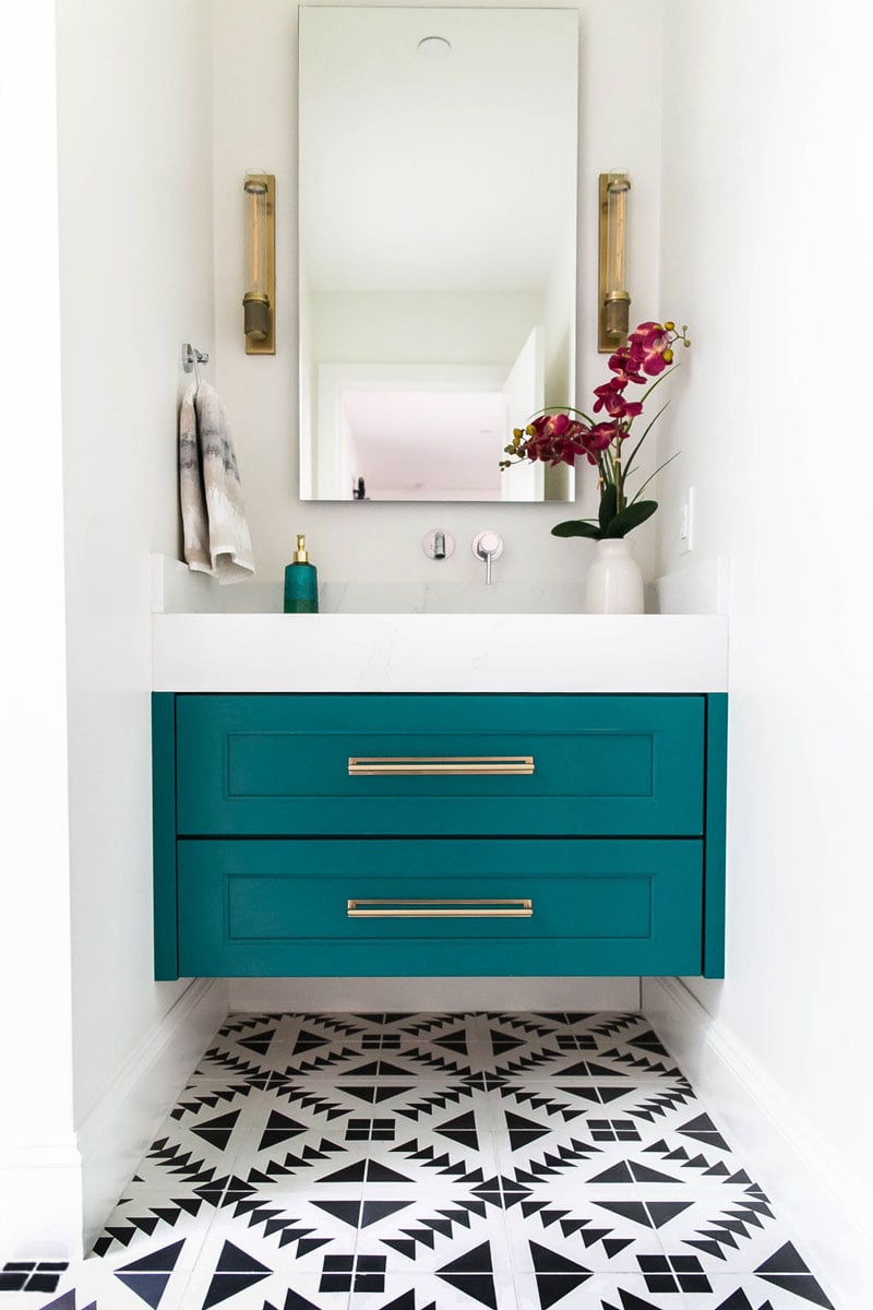 Teal vibrant bathroom drawers with flower decor