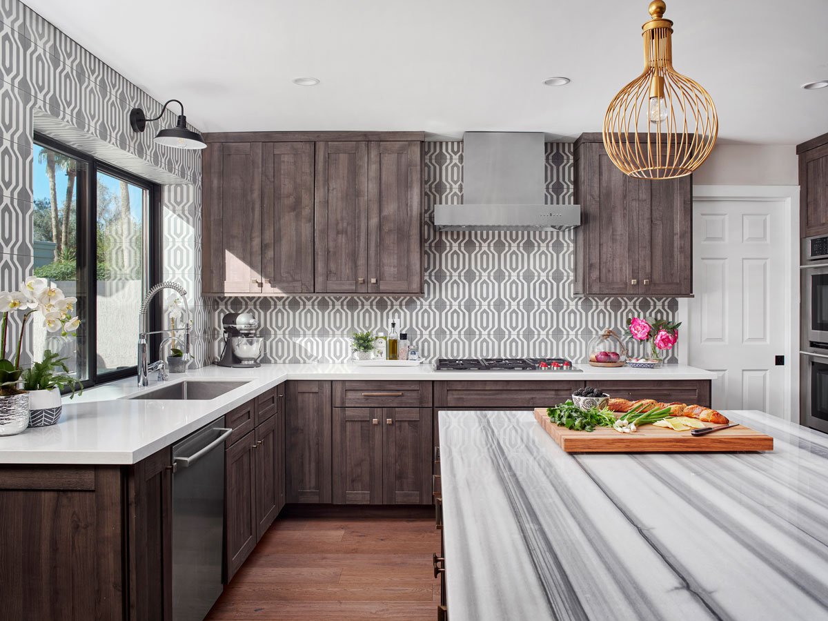 Wide shot of kitchen showcasing black and white striped island and wooden cabinets