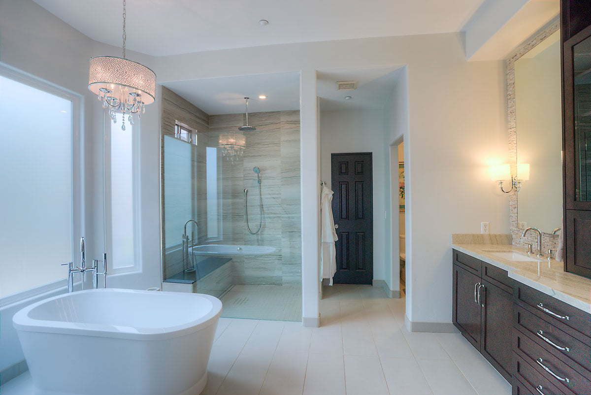Wide angle of master bathroom with stand alone tub and glass shower door