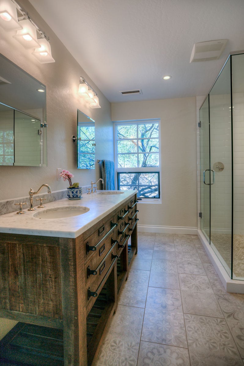Wide angle of powder bathroom with cream tile and walk in shower