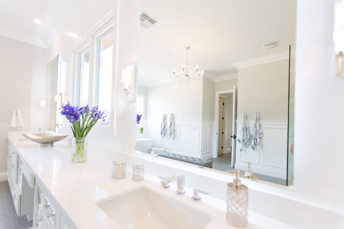Bathroom double vanity with mirrors and purple flowers