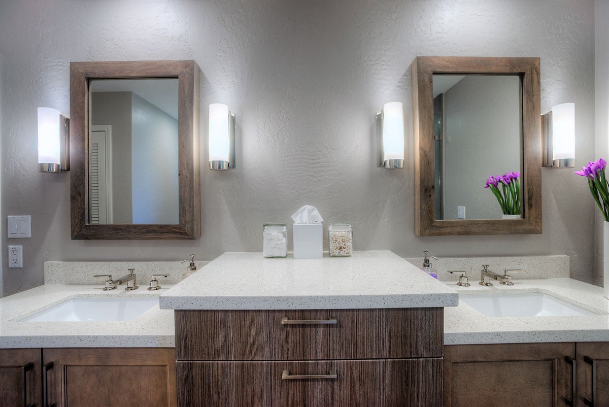 Master bathroom double vanity wide shot with white light fixtures